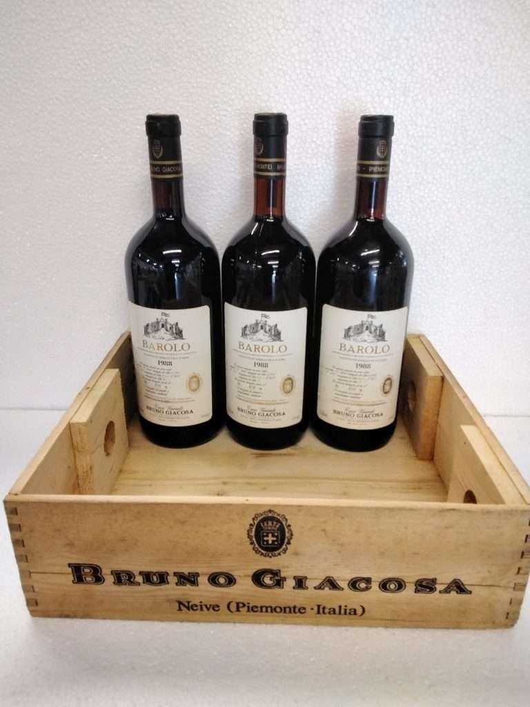 Three bottles of Barolo standing in a wooden Bruno Giacosa crate.